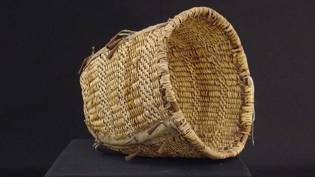 wide-mouthed basket with subtle bands of different colors of reed