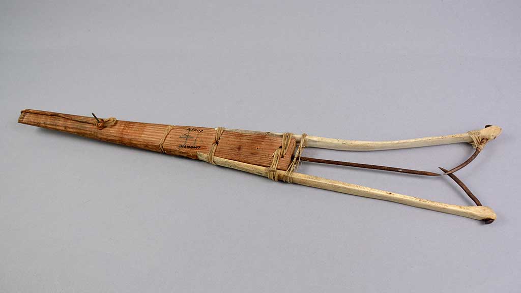 wooden handle with pointed pieces extending from one end